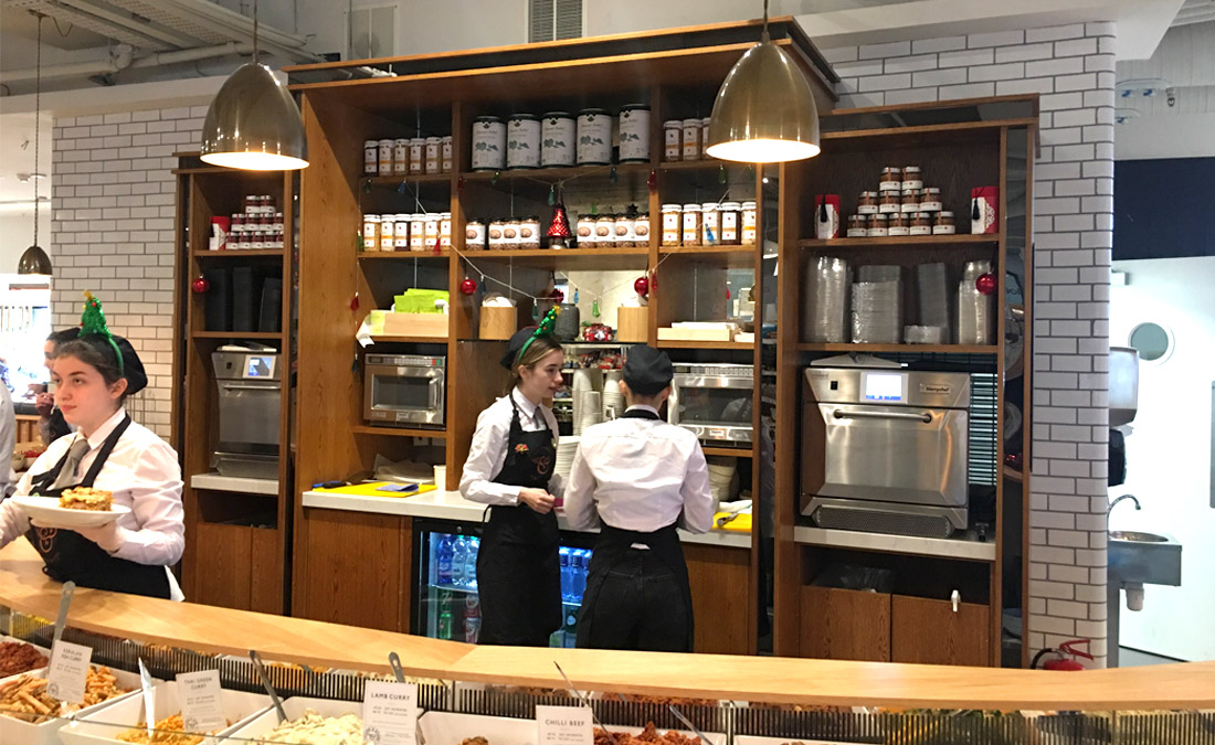 Wood display shelving behind front counter for Fallon and Byrne