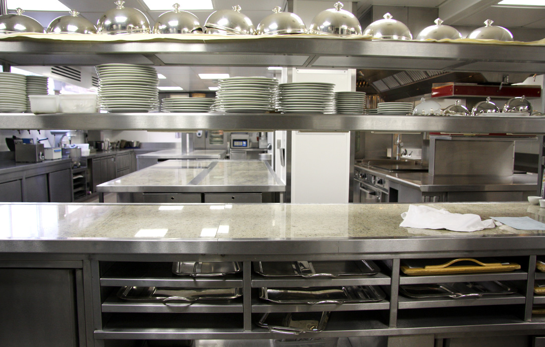 commercial Kicthen with stainless steel shelves, gantry and stone counter tops